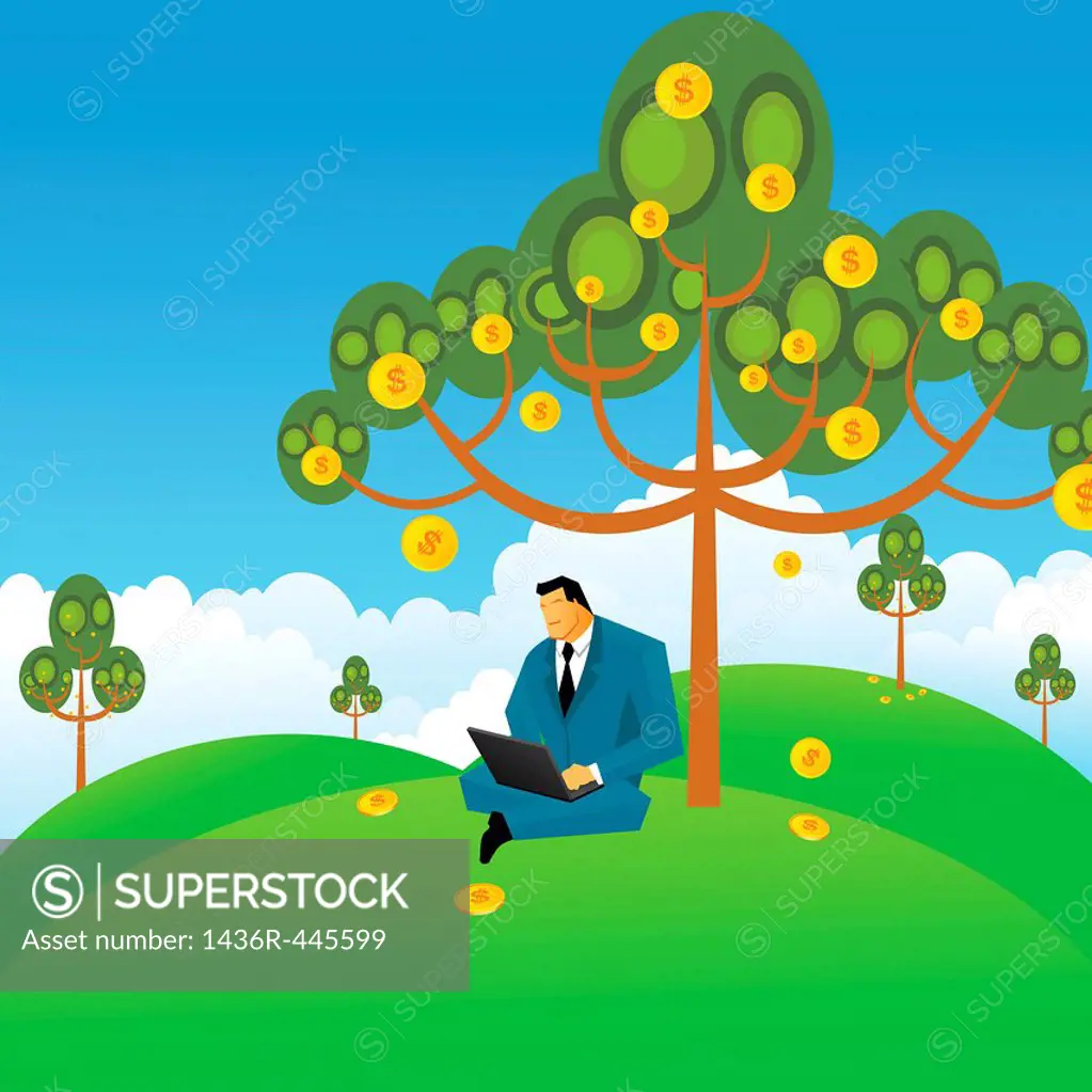 Businessman working on a laptop under the money tree