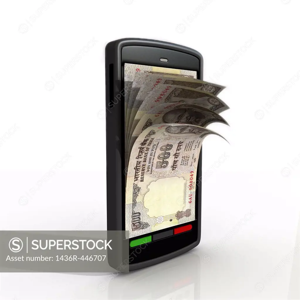 Conceptual shot of paper currency in cell phone depicting mobile banking