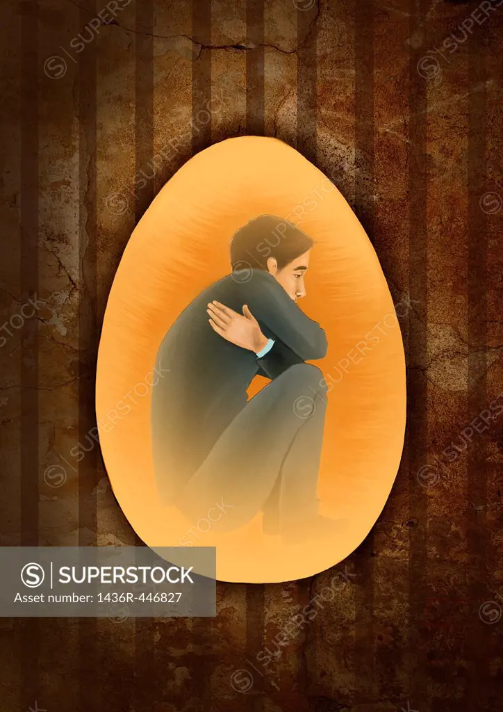 Side view of a man crouching inside egg depicting the concept of prisoner of mind