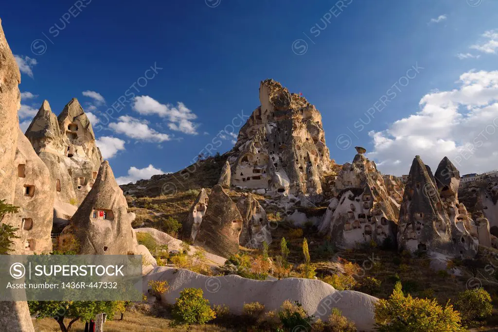 Ancient Uchisar Castle houses and tunnels at sunset carved out of volcanic tuff Cappadocia Turkey