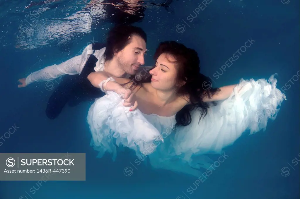 Bride and groom, ring, underwater wedding in pool, Odessa, Ukraine, Eastern Europe