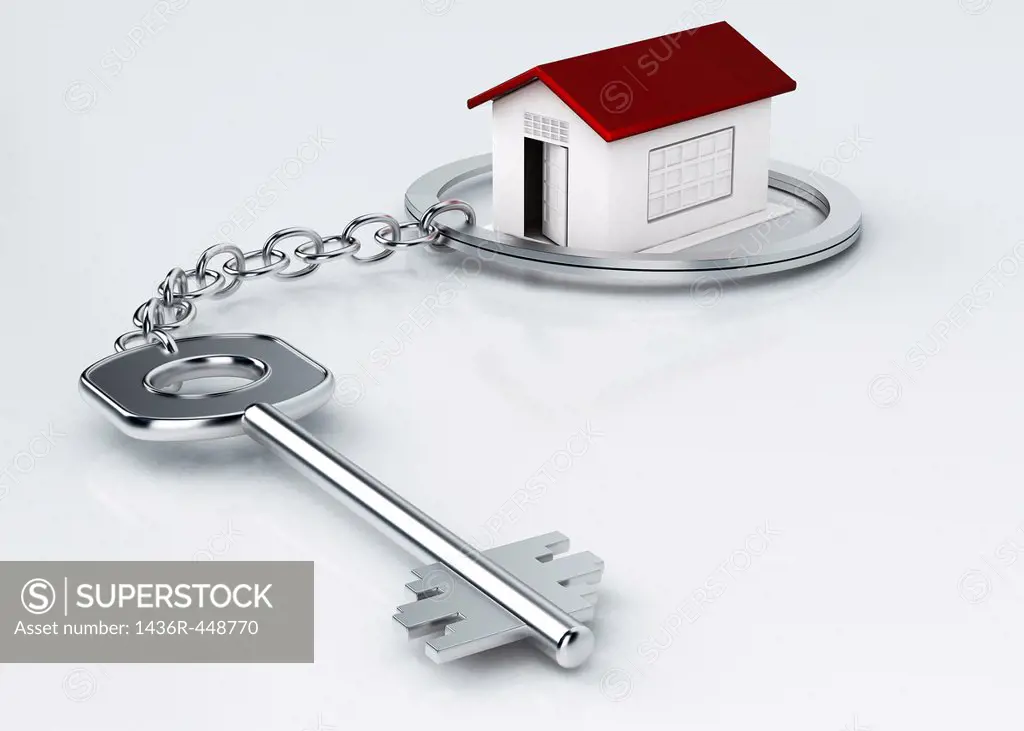 Model house surrounded by key ring over white background