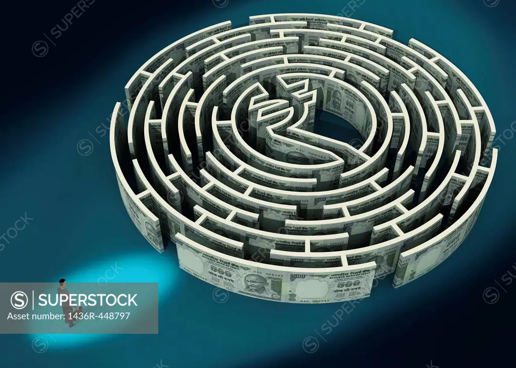 Businessman standing in front of a Indian Rupee maze