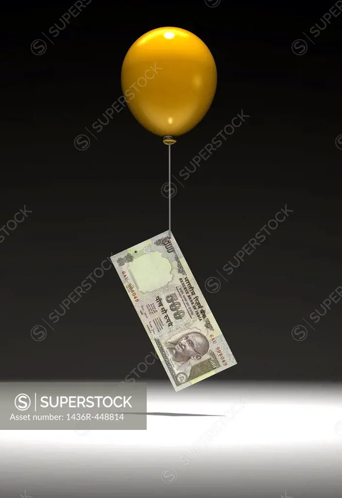 Indian five hundred Rupee note being lifted by balloon