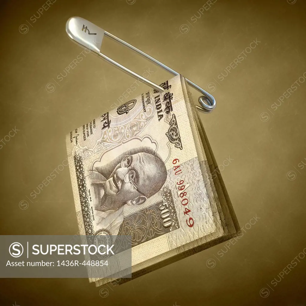 Indian five hundred rupee notes pinned in a safety pin