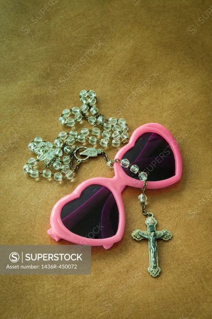 Crucifix on a pair of heart-shaped sunglasses.