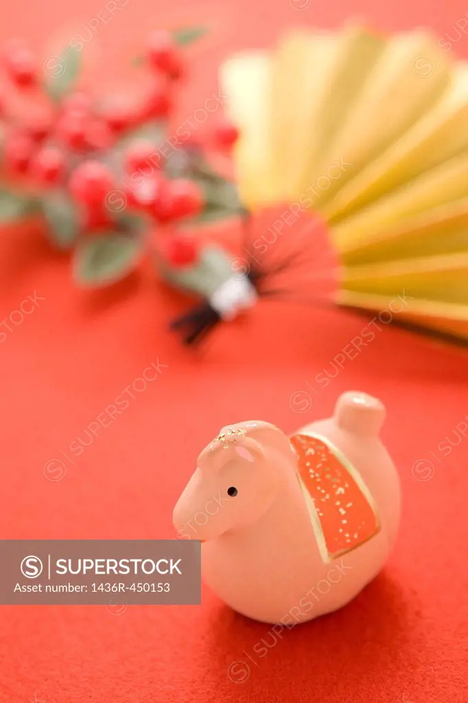 Toy Horse, Fan and Red Berry on Red Background