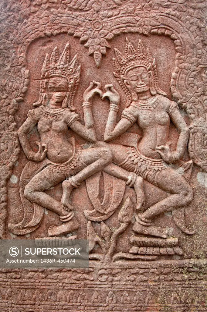 Bas-relief with Apsara figurines dancing on lotus flowers on the eastern terrace of Bayon temple in Angkor Cambodia.