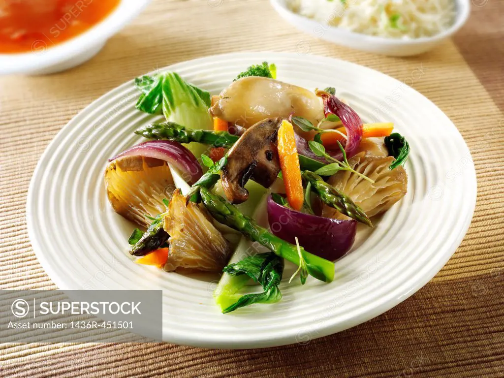 Oriental vegetarian stir fry of vegetables, noodle and mushrooms.