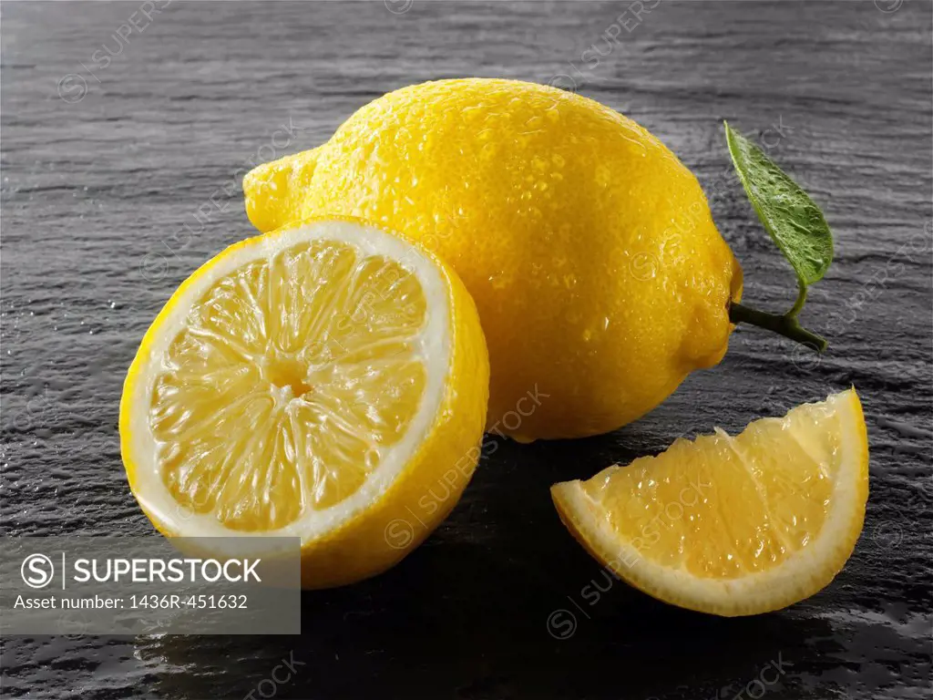 Fresh whole and cut lemons.