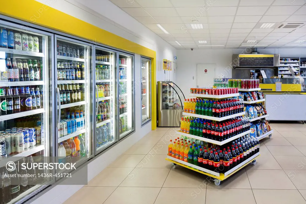 Convenience store of gas station in Estonia. Cold beverages on shelves, furnishing. Shop interior, shopping. Self service.