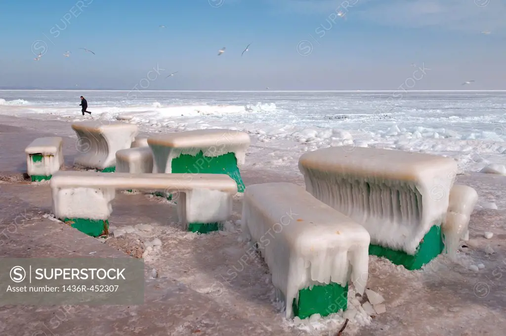 Icy cafe tables and benches on the beach of the frozen Black Sea, a rare phenomenon, last time it occured in 1977, Odessa, Ukraine, Eastern Europe.