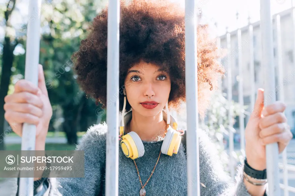 Young woman holding onto railings