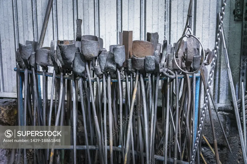 Rows of tools and tongs in industrial forge