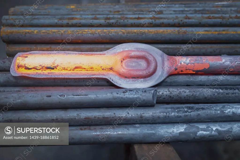 Hot forged steel part in industrial forge