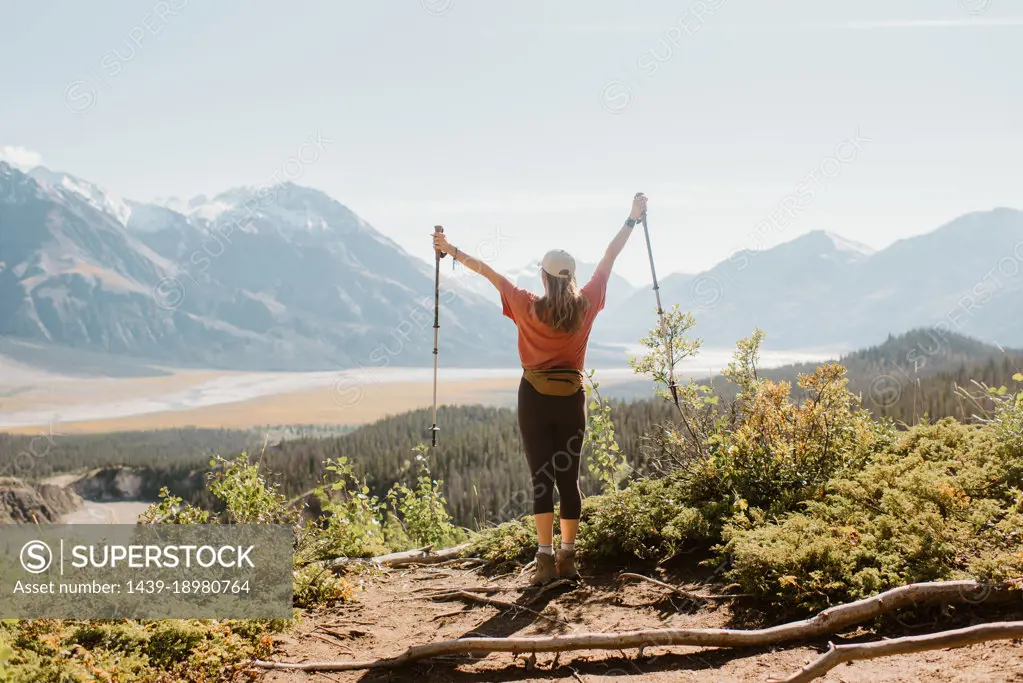 Canada, Whitehorse, Rear view of woman with hiking poles in landscape