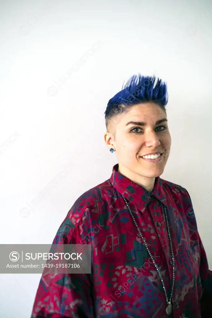 Studio portrait of smiling non-binary person