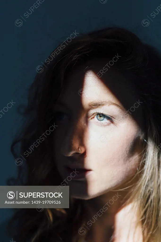 Young woman with shadow on face