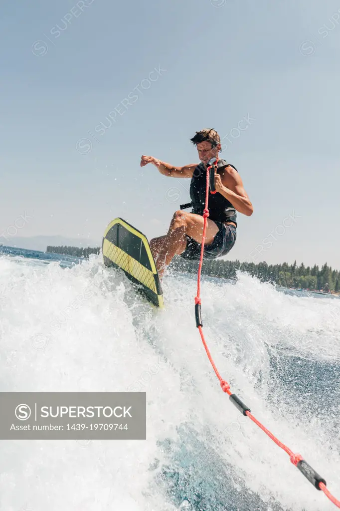 Man wakeboarding at lake