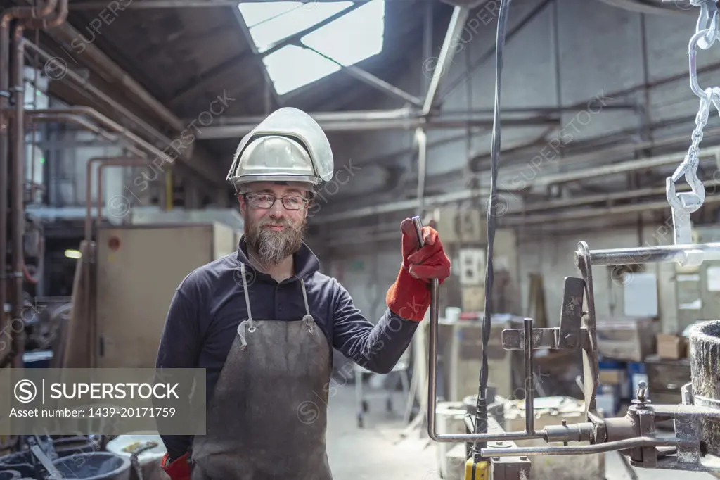 Portrait of apprentice foundry worker in brass foundry