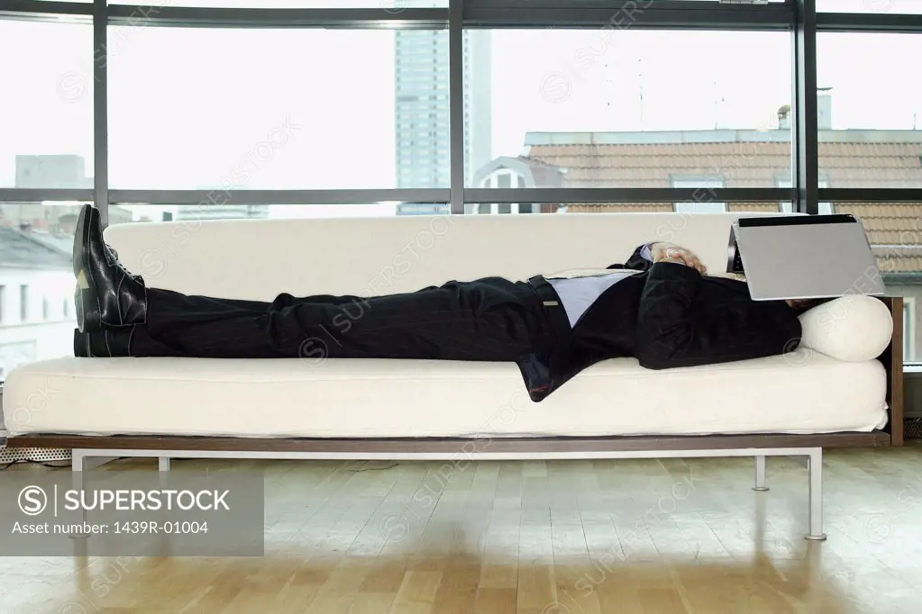 Businessman reclining on sofa