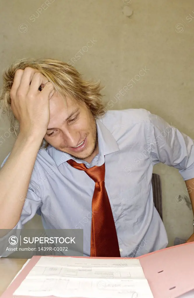 Smiling office worker reading document
