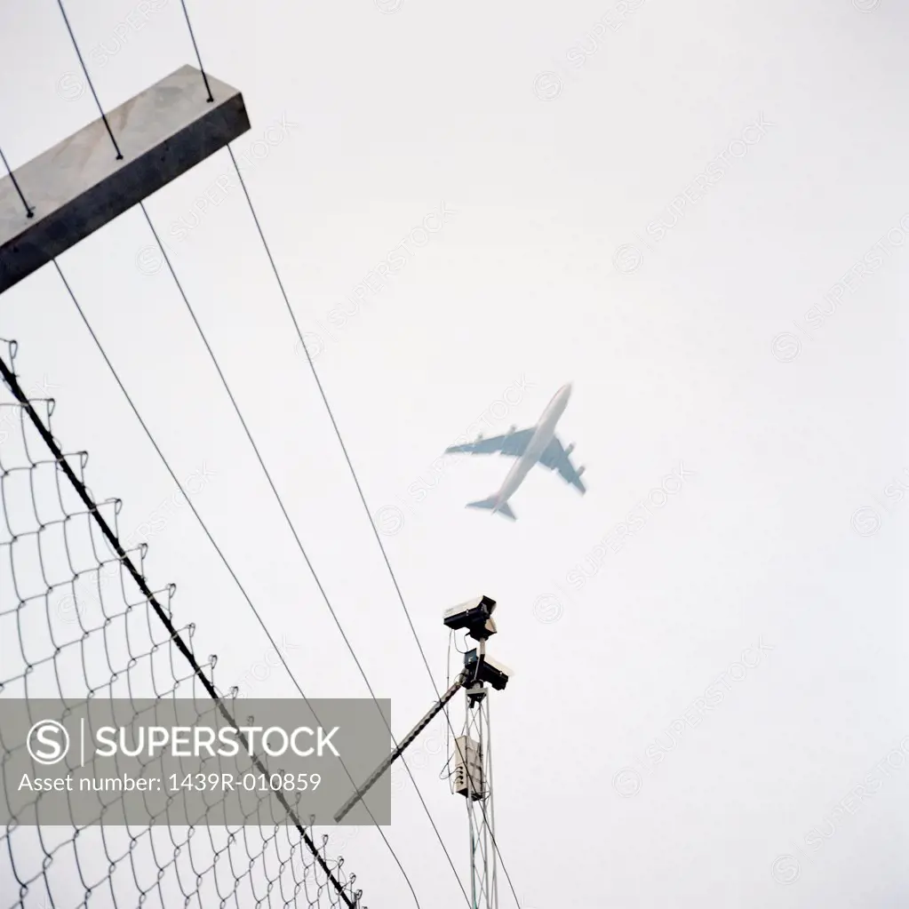 Aeroplane above wire fence