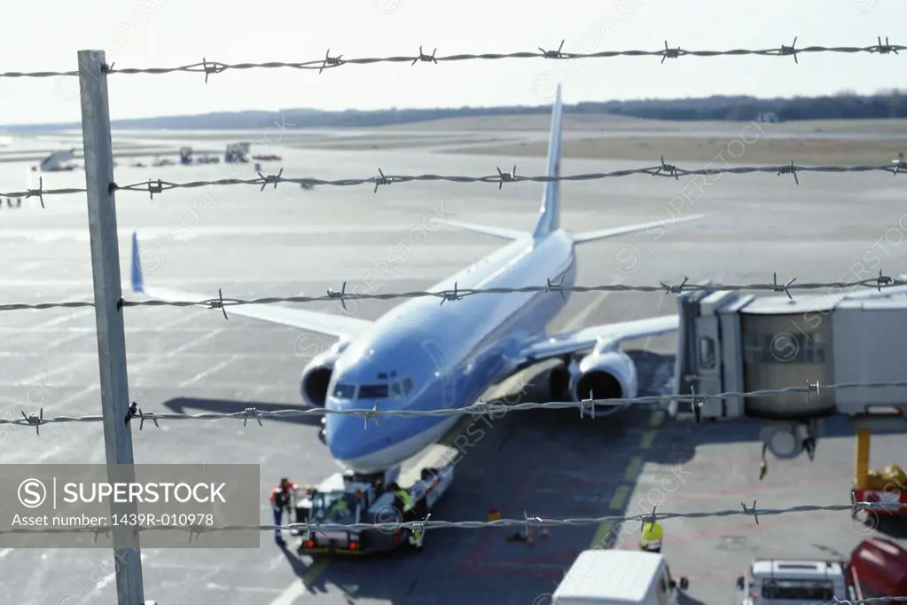 Aeroplane behind barbed wire fence
