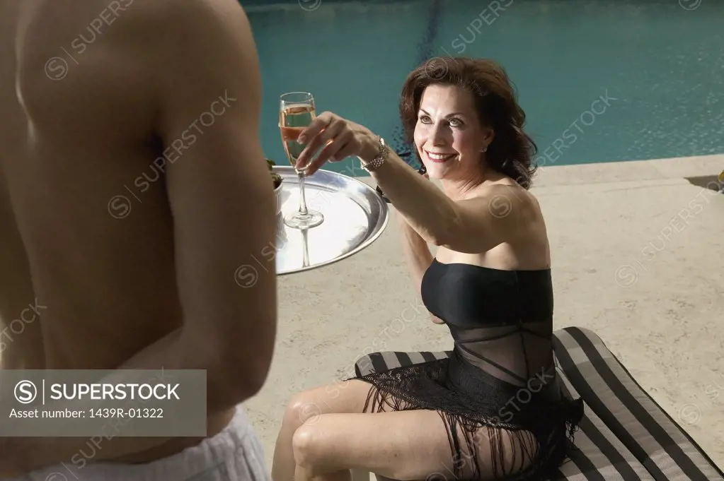Woman reaching for champagne flute