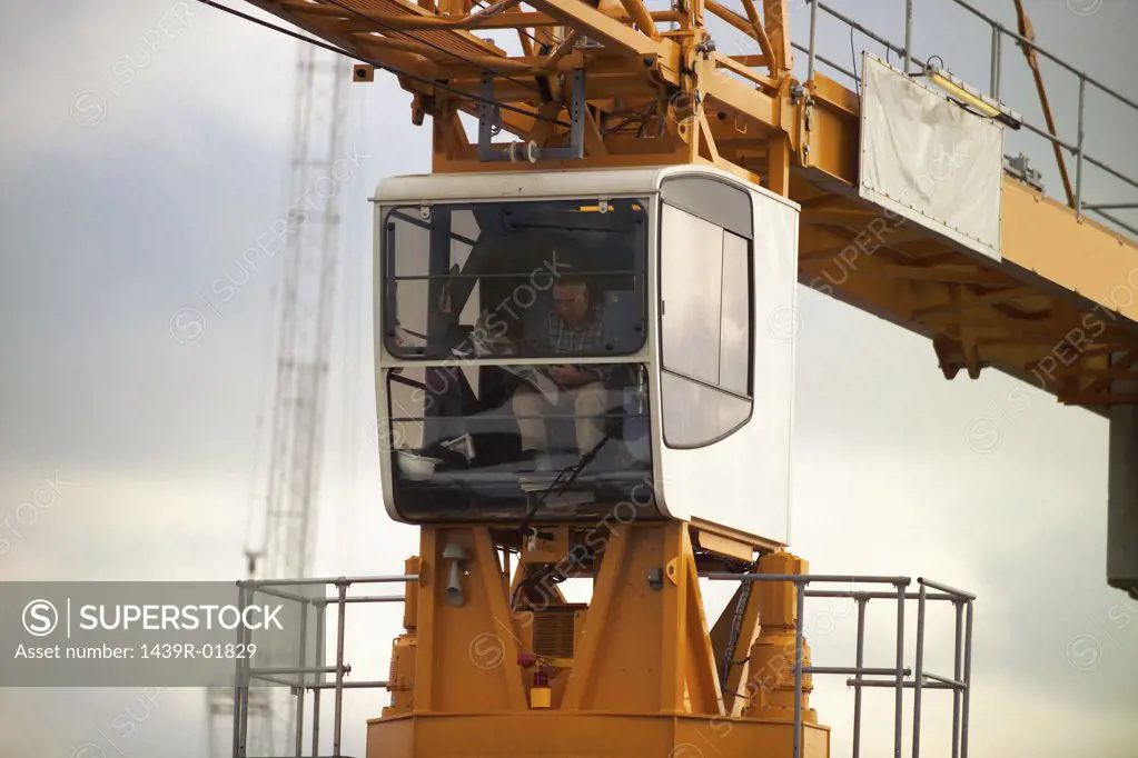 Crane operator in crane cabin 