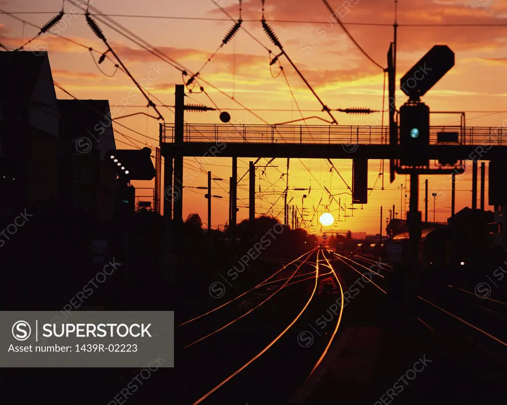 Empty railroad tracks at sunset