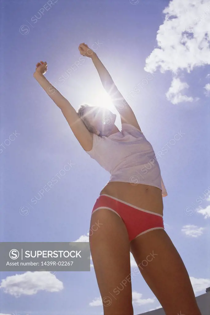 Woman stretching in sunlight