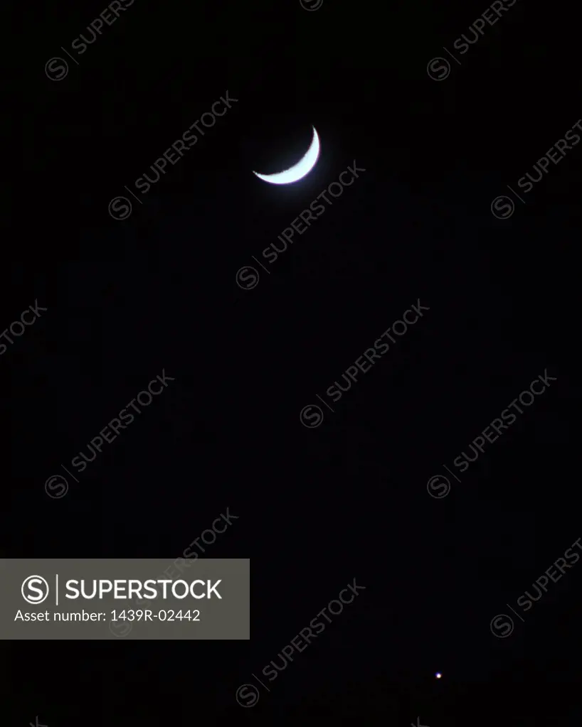 Crescent moon in sky