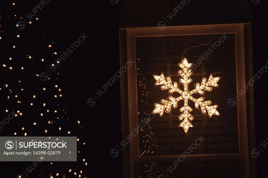 Illuminated star shape in window