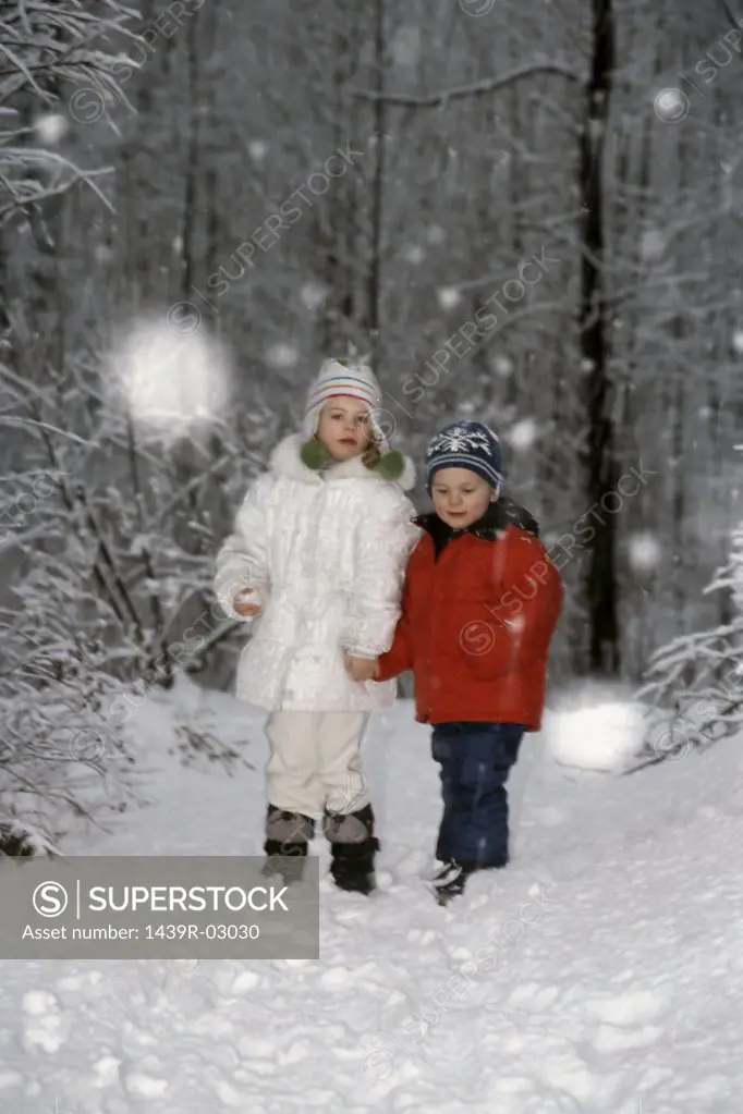 Children standing in a forest
