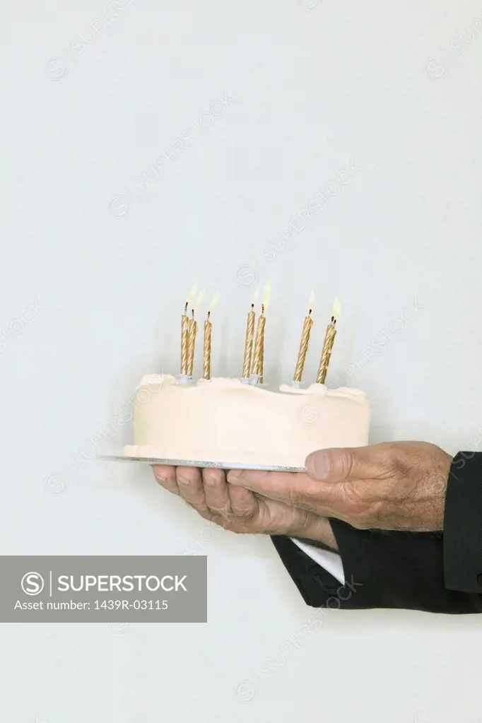 Senior man holding a birthday cake