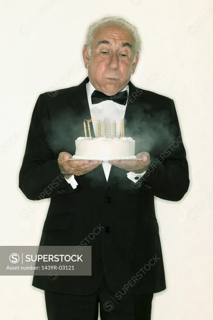 Senior man holding a birthday cake