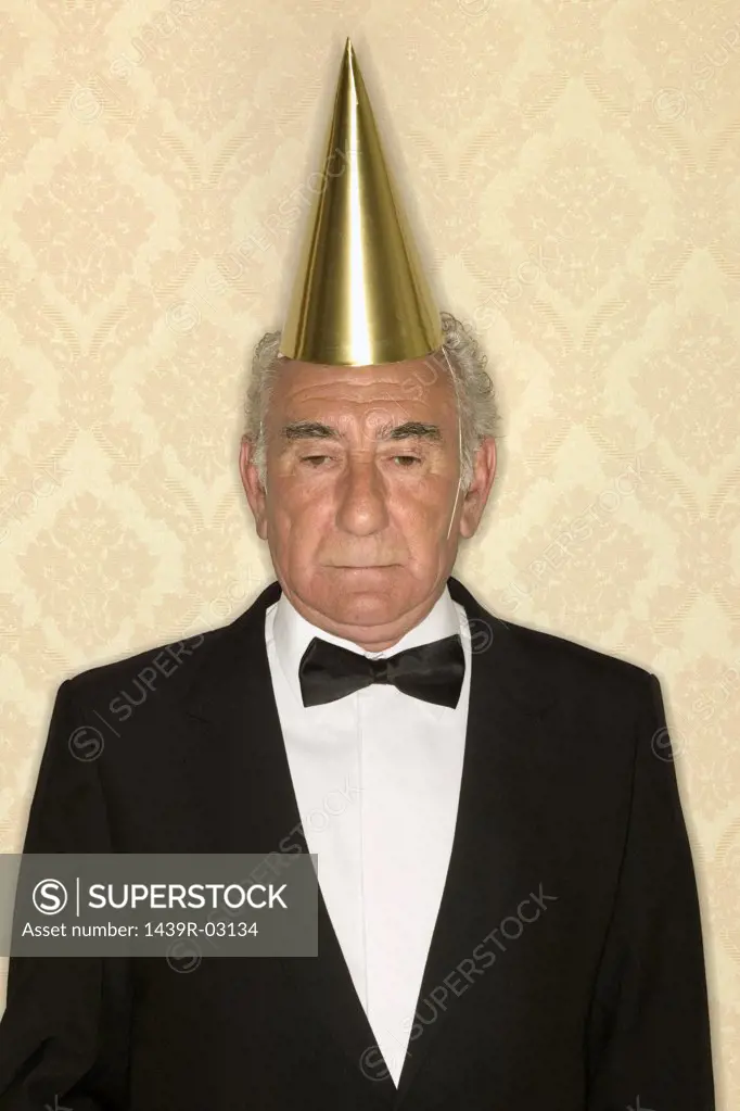 Senior man wearing party hat