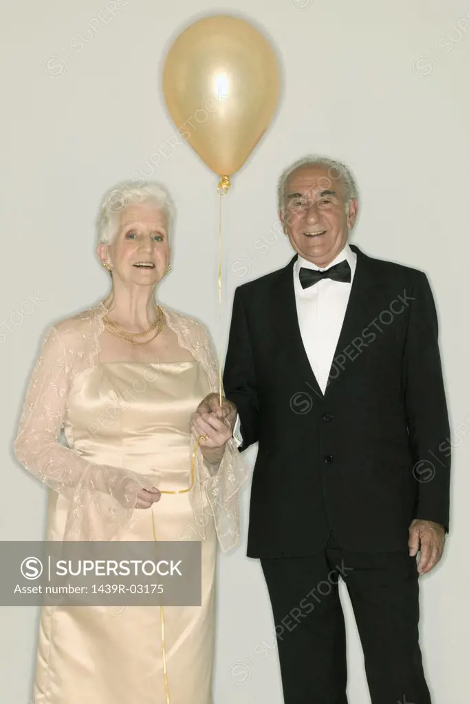 Senior couple holding a balloon