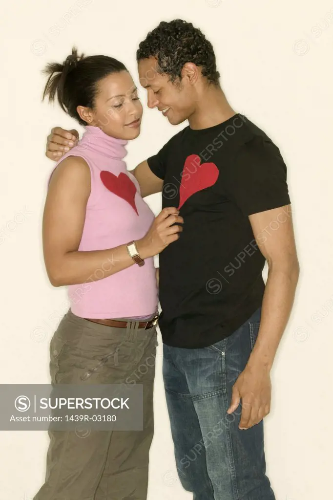 Young couple wearing heart shapes