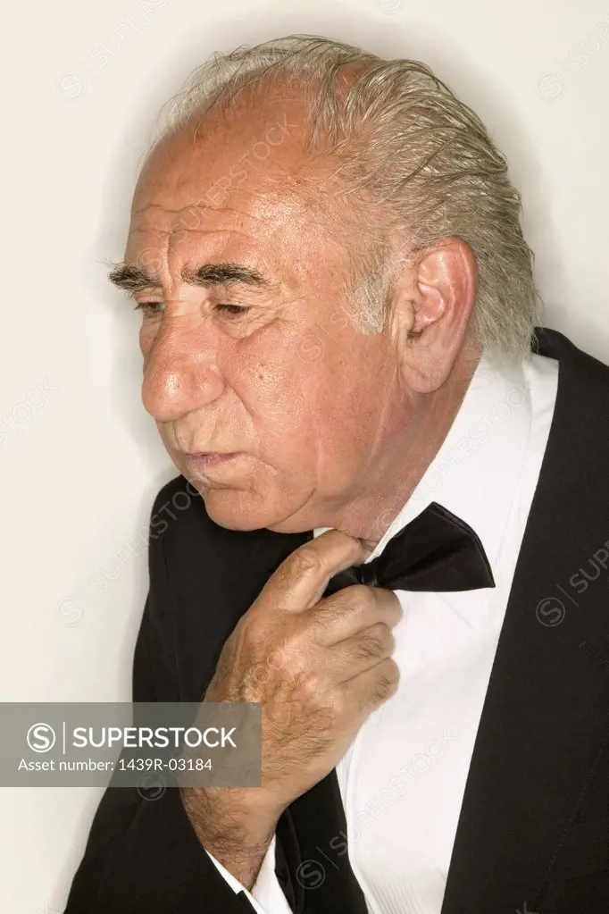 Senior man adjusting bow tie