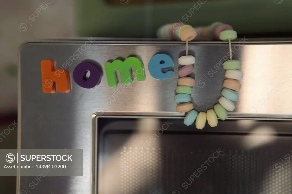 Letter magnets on microwave oven