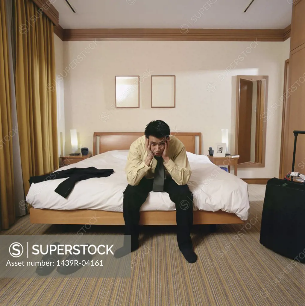 Bored businessman in hotel room