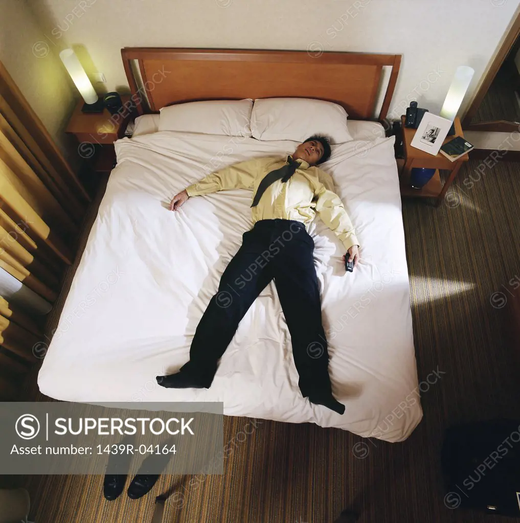 Businessman sleeping in hotel room