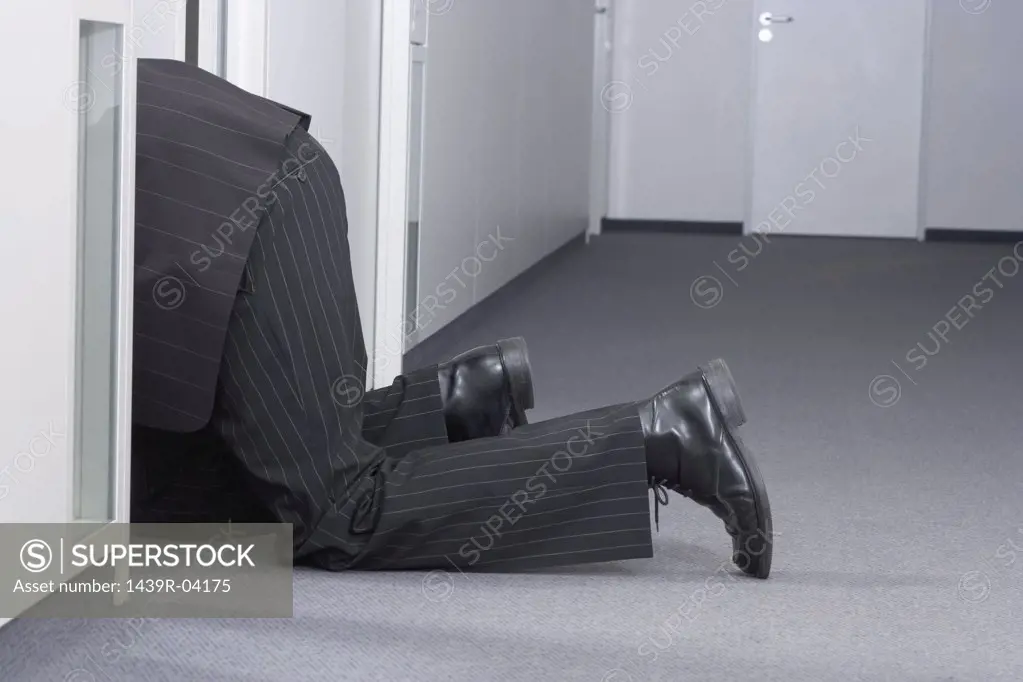 Businessman crawling on floor