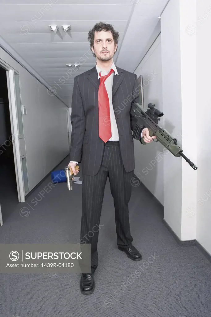 Businessman with a rifle and handgun