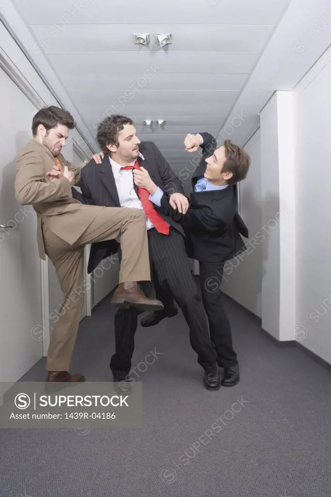 Businessmen fighting in corridor