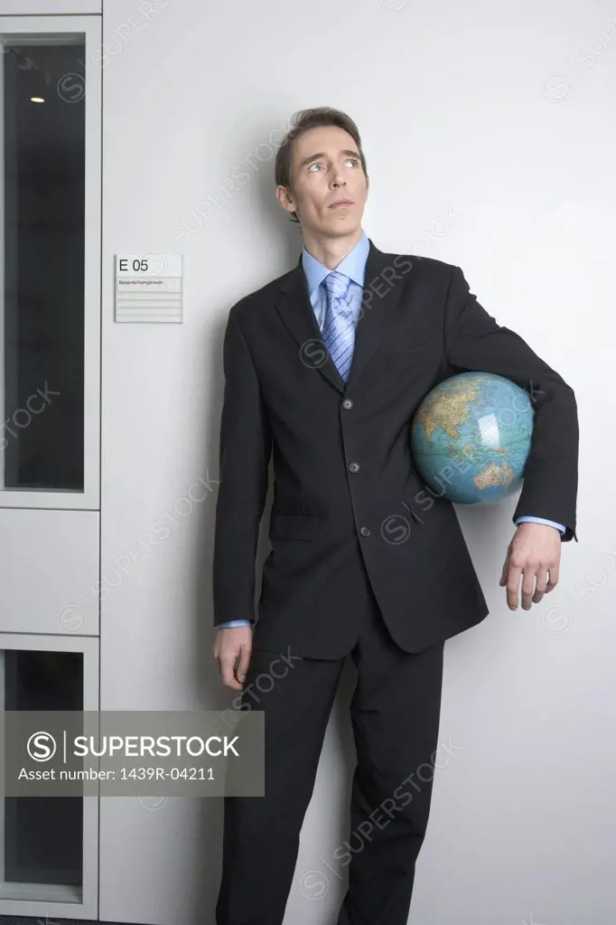 Businessman holding globe