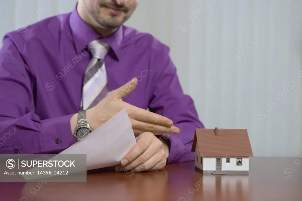 Estate agent with model house