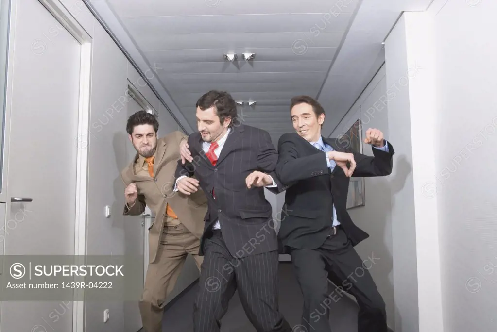 Businessmen fighting in corridor